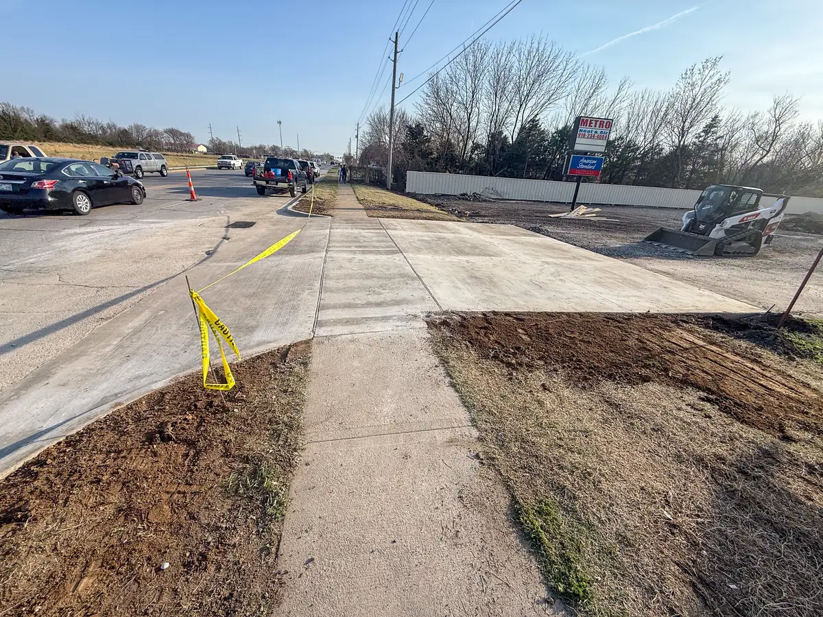 New concrete sidewalk and approach at a commercial parking lot