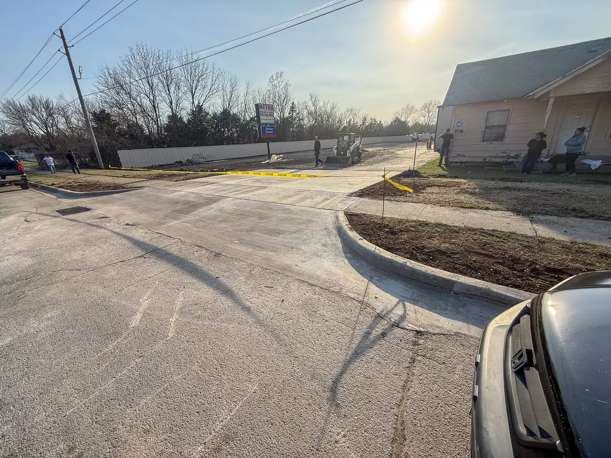 New concrete drive approach with curb at a street entrance