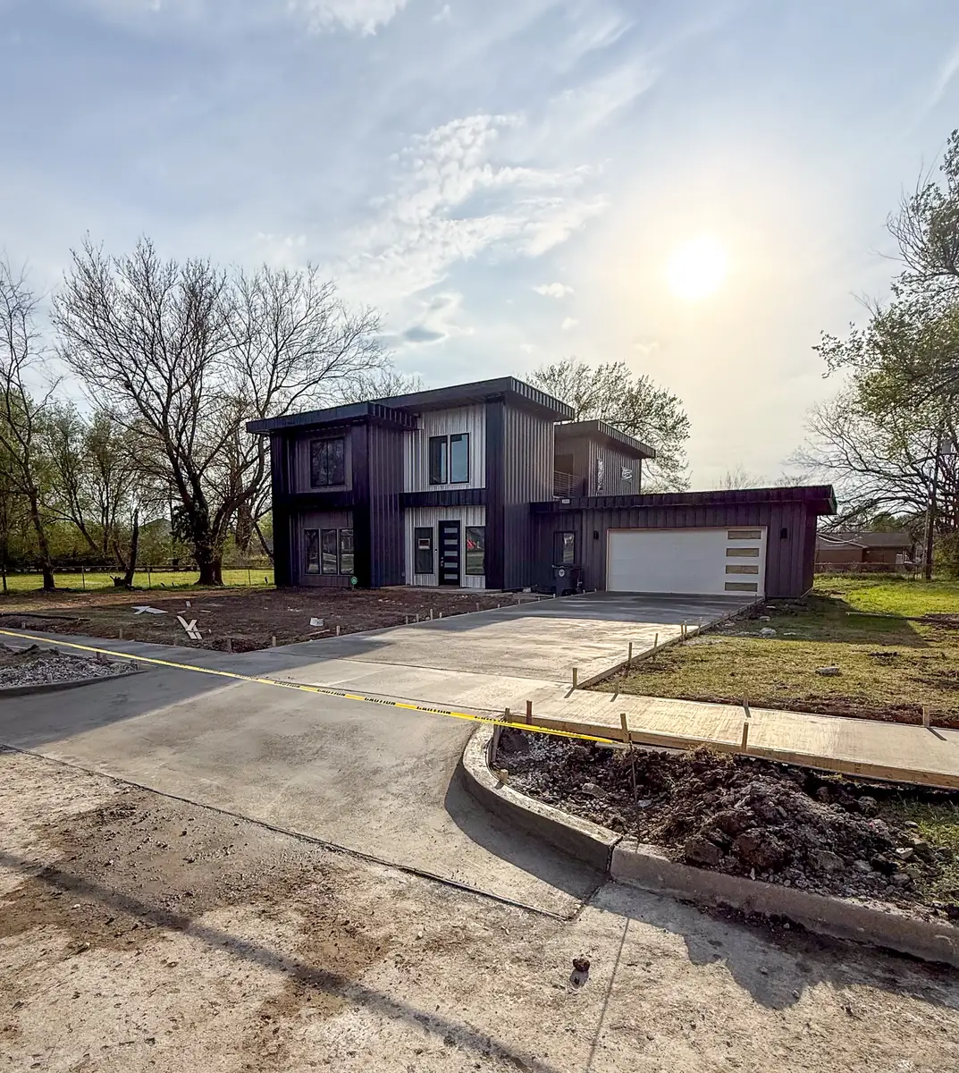 Finished concrete driveway and sidewalk at a new two-story home