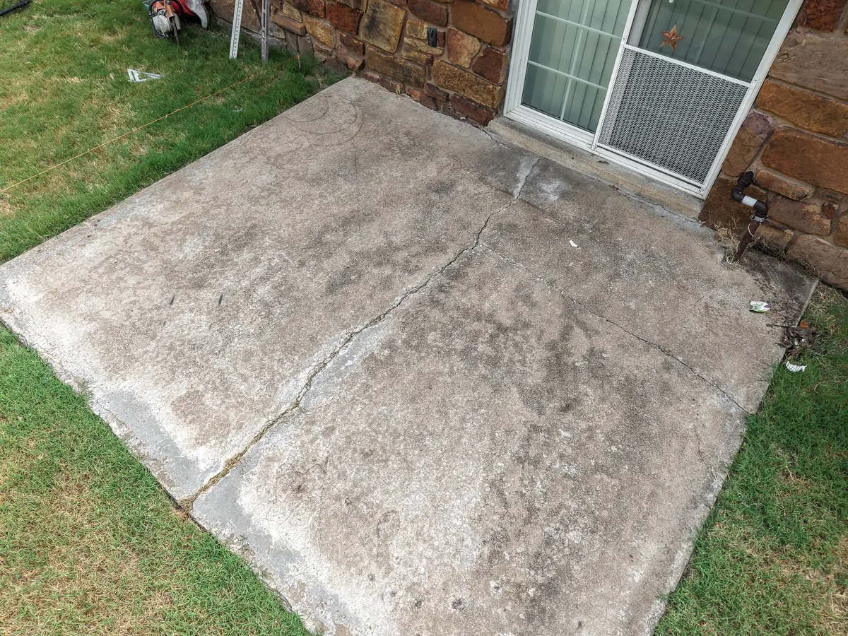 Worn concrete patio slab before replacement