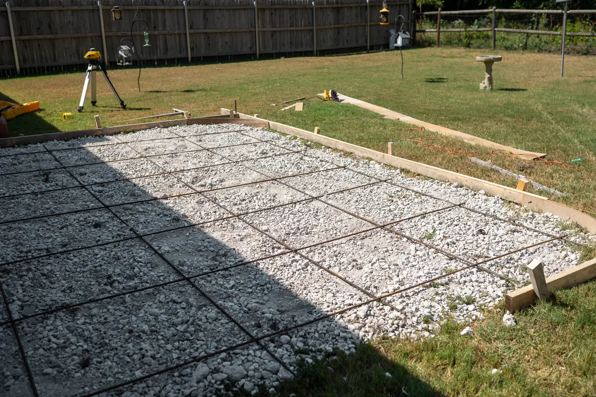 Backyard patio prep with forms, gravel, and rebar