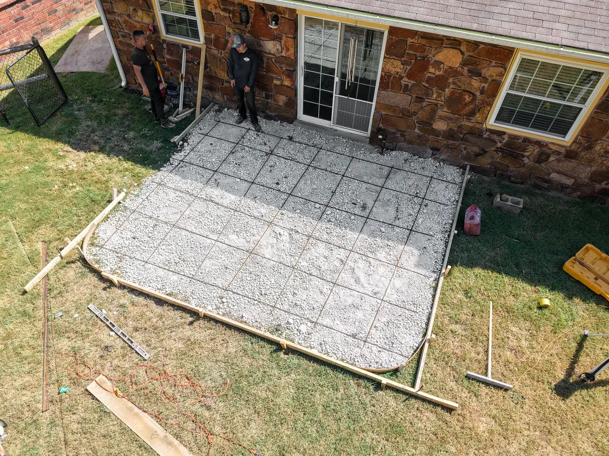 Crew setting rebar inside patio forms, aerial view