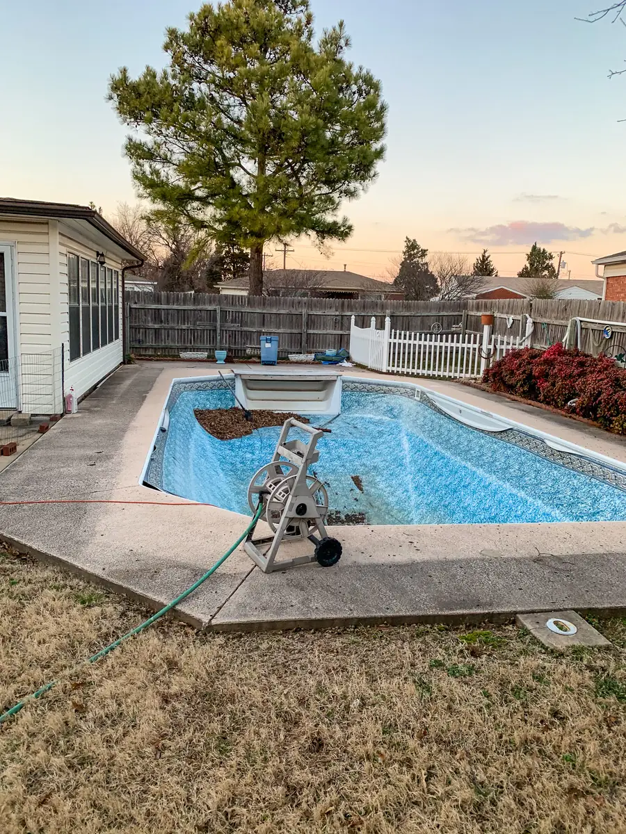 Concrete pool deck surrounding an inground pool
