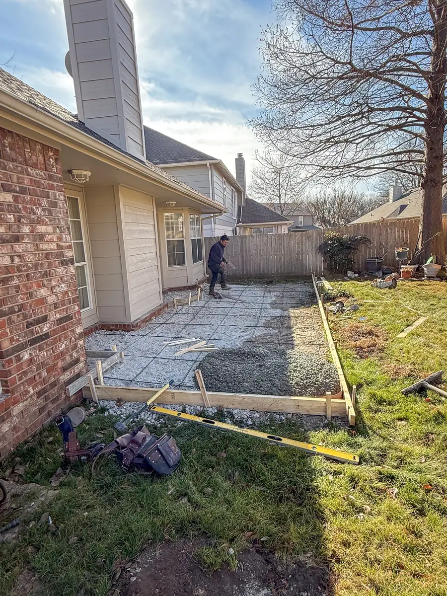 Forms and gravel base set for a side-yard patio extension