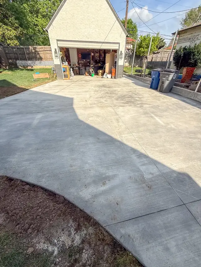New concrete driveway leading to a detached garage